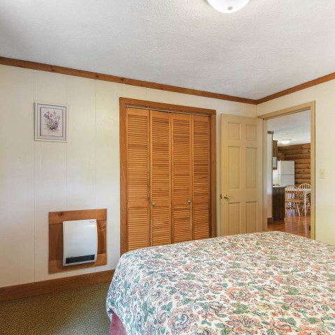 a bedroom with a bed in a room