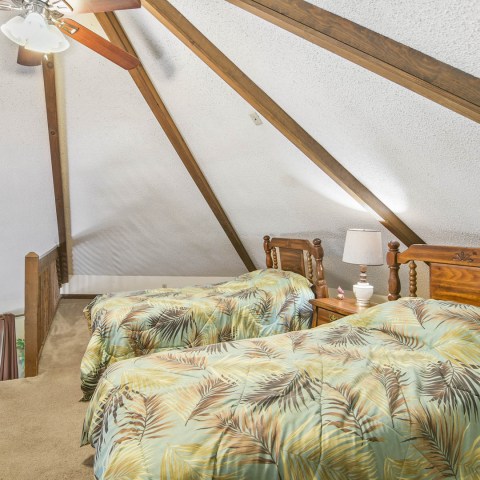 a bedroom with a bed and chair