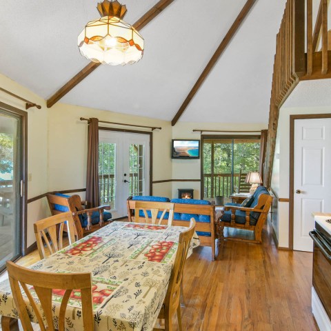 a kitchen with wooden cabinets and a dining room table