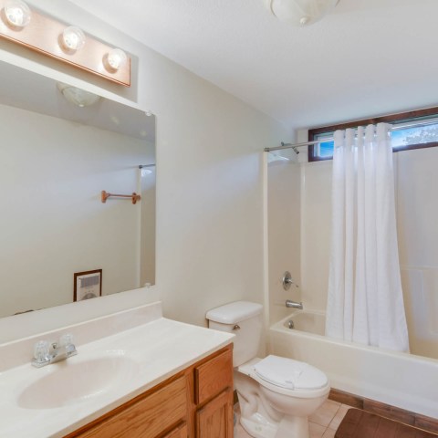 a large white tub next to a sink