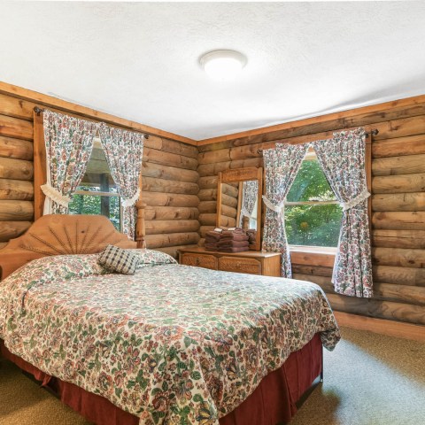 a bedroom with a bed in a room