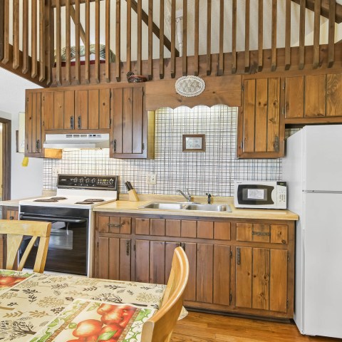 a kitchen with wooden cabinets