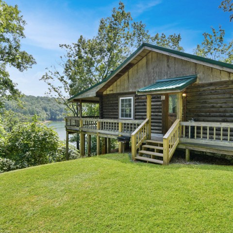 a group of lawn chairs sitting on top of a grass covered field