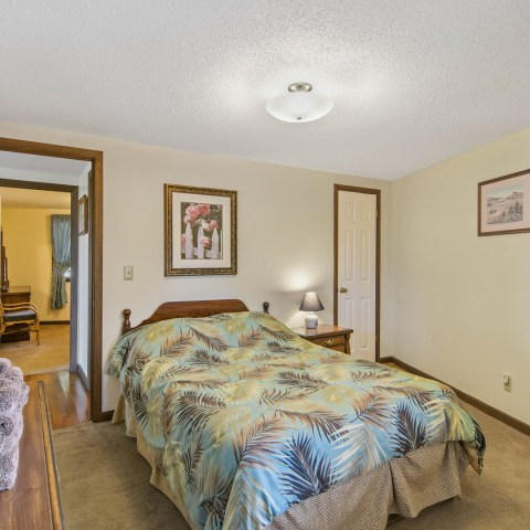 a bedroom with a bed in a room