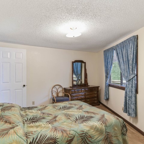 a bedroom with a bed in a room