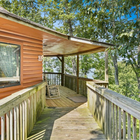 a wooden bench on the side of a building