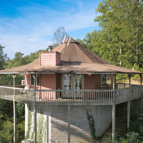 a house with a fence in front of a building