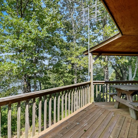 a wooden bench sitting next to a fence