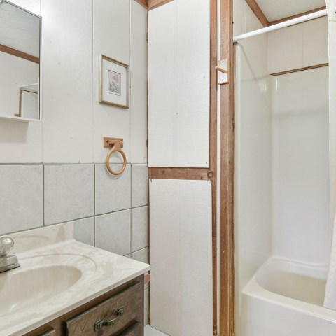 a white tub sitting next to a sink
