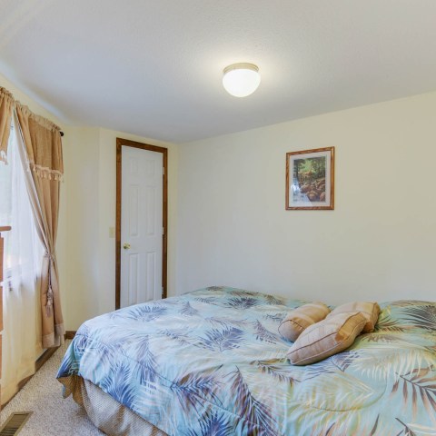 a bedroom with a bed in a room