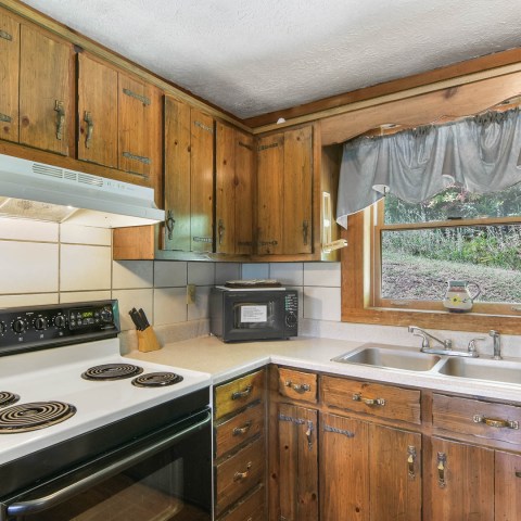 a kitchen with stainless steel appliances and wooden cabinets