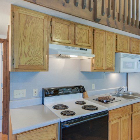 a kitchen with a stove sink and refrigerator
