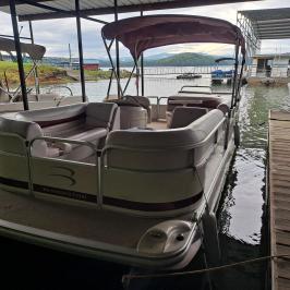a boat sitting on top of a sandy beach