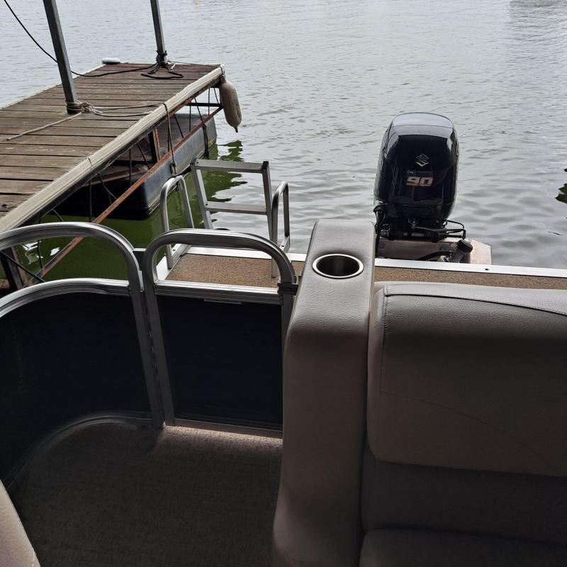 a boat that is sitting on a chair next to a body of water