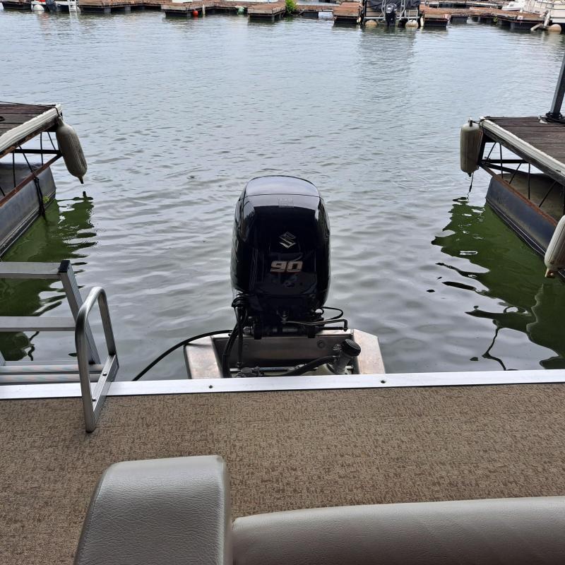 a boat that is sitting on a bench next to a body of water