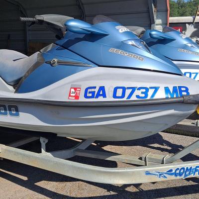 a blue and white airplane parked in a parking lot