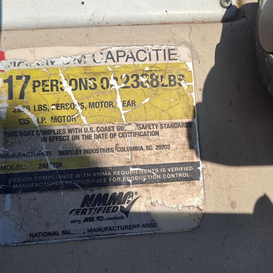 Worn capacity plate for 17 persons or 2338 lbs on a boat.