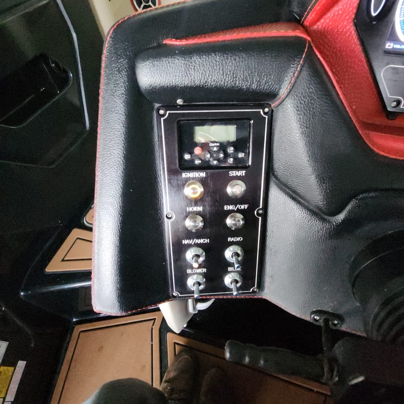 Car dashboard with buttons and display screen in a vehicle interior.