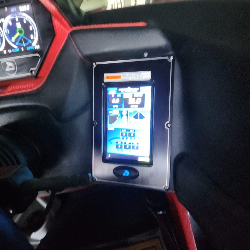 Car dashboard with digital touchscreen display and gauges.