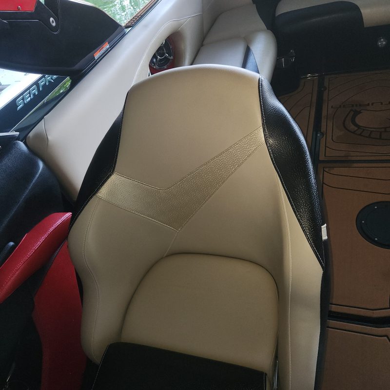 Boat interior with leather seats and cup holders.