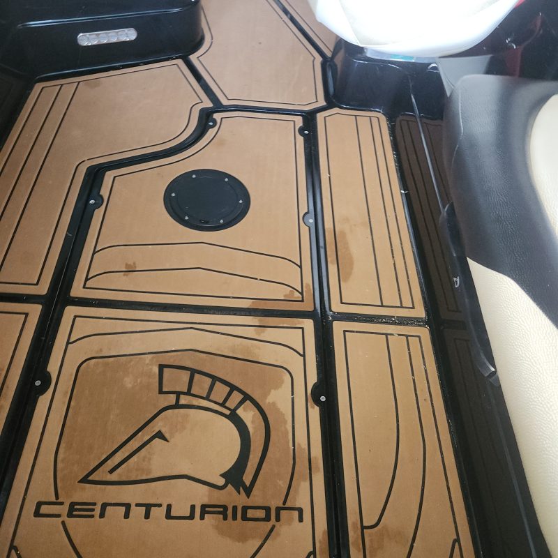 Boat deck with Centurion logo and patterned floor mats.