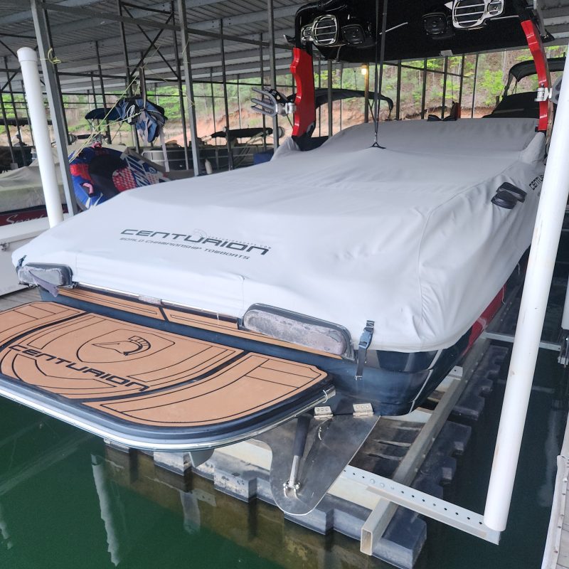 Covered boat docked in a sheltered marina area.