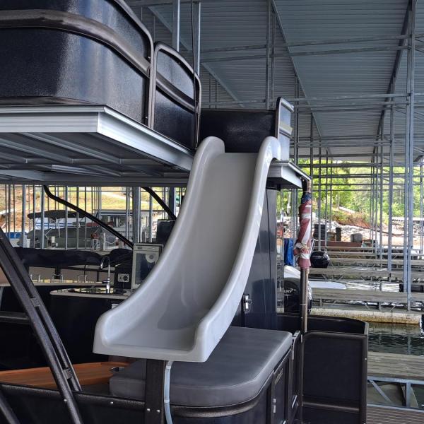 Boat with a slide on a covered dock.