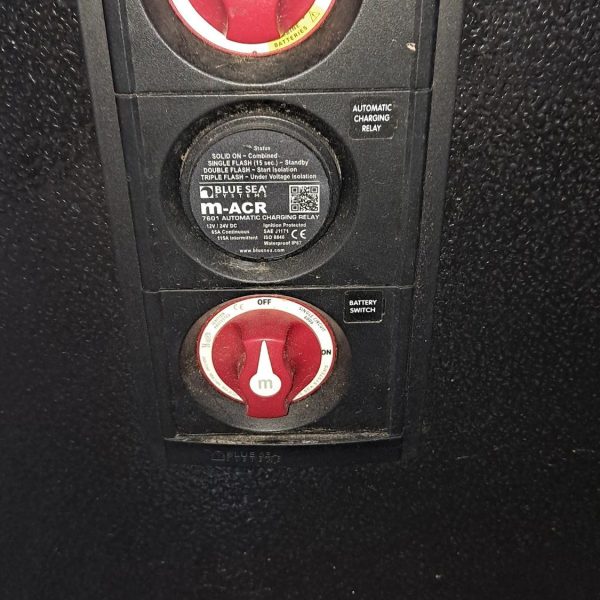 Close-up of electrical switches and a circuit breaker on a panel.