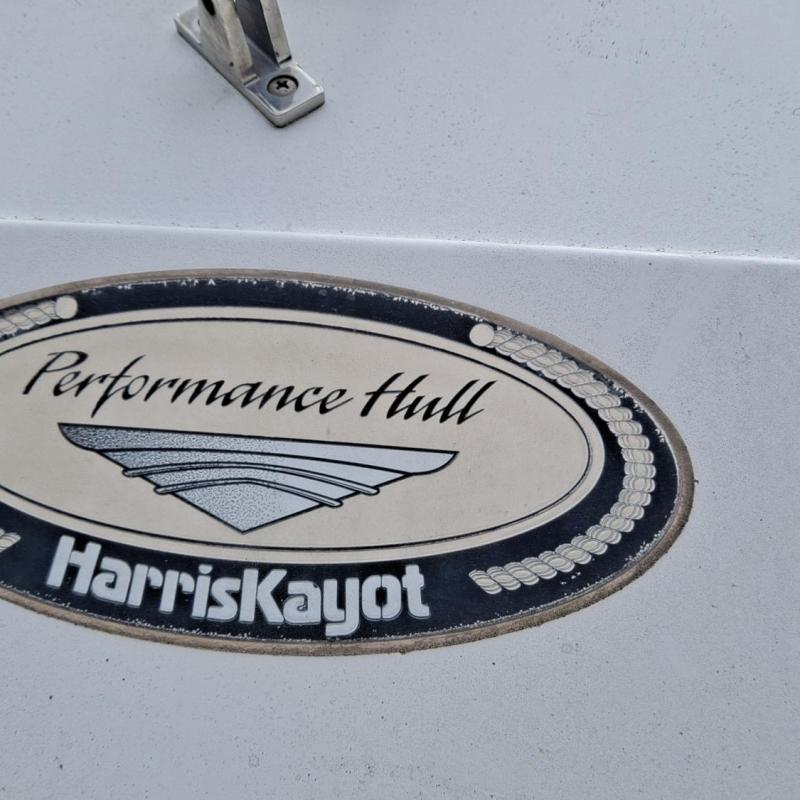Oval emblem reading 'Performance Hull HarrisKayot' on a white surface.