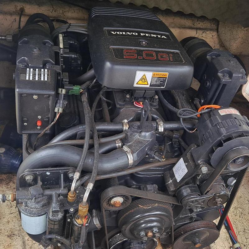 Boat engine in compartment with Volvo Penta label.